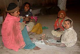 A family collecting alms for a living passes the freezing night in cold solitude
