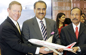 Civil Aviation Minister Praful Patel (centre) looks on as Boeing Commercial Airplanes President Alan Mulally (left) and Air-India Chairman V. Thulasidas pose with a model Boeing aeroplane after signing a deal in Mumbai on Wednesday.