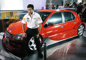Formula One driver Narain Karthikeyan poses with the newly unveiled Tata Indica Formula Concept car during Auto Expo, 2006, in New Delhi on Friday