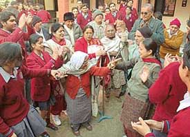 Students of DAV Public School, Sector 15, celebrate Lohri with inmates at an Old Age Home in Chandigarh on Friday