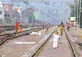 Unmindful of the danger, a child tries his hand at kite flying on the railway track at Ludhiana railway station