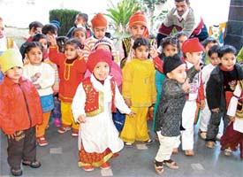 Tiny tots of Shemrock Kindergarten in playful mood during Lohri celebrations in Ludhiana on Friday