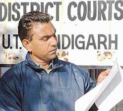 Mr Madan Lal, a guarantor, shows documents in support of his claims.