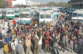 Haryana Roadways employees block a road during a protest in Panchkula on Saturday.