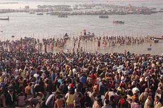 Devotees take a holy dip at the sangam in Allahabad on the occasion of Makar Sankranti