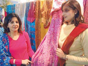 The city has a booming textile business. Visitors from Pakistan shopping at Amritsar.
