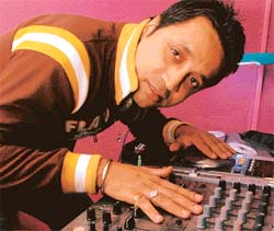 DJ T-nu on the keyboards at a party in town