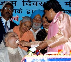 BSP leader and former UP Chief Minister Mayawati offers a piece of cake to senior leader Kanshi Ram on the occasion of her 50th birthday at her residence in New Delhi