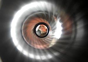 A soldier peeps through the barrel of a gun on display at Army mela in Amritsar on Sunday.