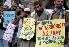 Activists from Muttahida Majilis-e-Amal hold placards during a protest in Islamabad