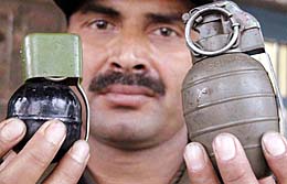An army jawan displays seized ammunition at Miran Sahib Army Brigade Headquarters near Jammu on Tuesday.