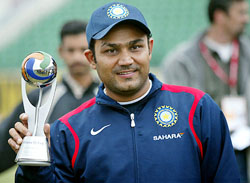 Virender Sehwag holds the man of the match trophy at the Gaddafi Cricket Stadium in Lahore on Tuesday