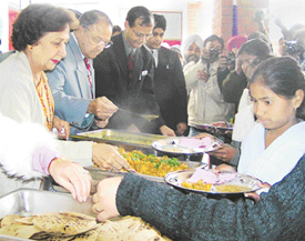 Schoolchildren being served food at Government Primary School, Sector 52, by UT Administrator S.F. Rodrigues and Ms Jean Rodrigues at the launch of pilot mid-day meal programme in Chandigarh on Wednesday.