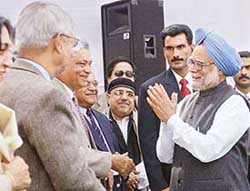 Prime Minister Manmohan Singh interacts with faculty members of the Delhi School of Economics at a function to mark the annual day and 50th anniversary of the school in New Delhi on Tuesday.