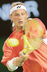 Argentinas David Nalbandian hits the ball during a second round match against Swiss player Stanislas Wawrinka at the Australian Open in Melbourne on Wednesday