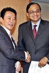 Finance Minister P. Chidambaram shakes hands with Japanese Foreign Minister Taro Aso prior to their talks in Tokyo on Wednesday