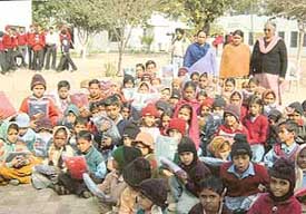 Students with the donated sweaters in Sohana on Thursday.