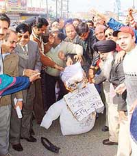 Activists of the Bharatiya Janata Yuva Morcha burn an effigy of the Punjab Government in protest against price rise in Ludhiana on Thursday. 