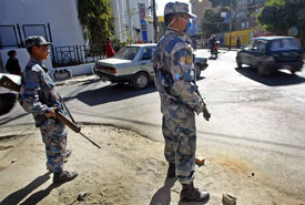 Policemen stand guard at the Naxal street corner in Kathmandu on Thursday.