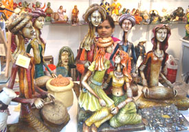 An attendant at a stall of statues at the International Furniture Fair in New Delhi on Friday. The fair will continue till Sunday.