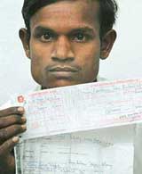 Ram Avtar shows the bill of Rs 10,000 sent to him by UHBVN at Panchkula on Friday