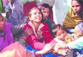 The wailing mother of the children killed in a wall collapse at Chaheru, near Phagwara, is being consoled by her relatives and friends
