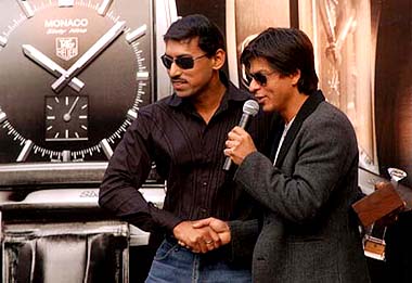 Olympic silver medalist Rajyavardhan Rathore shakes hands with Shah Rukh Khan after being honoured with the TAG Heuer Young Achiever award at the launch of a TAG Heuer watch in New Delhi on Sunday