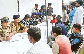 Chandigarh Police personnel register details of servants during a special drive in Sector 40, Chandigarh, on Sunday.