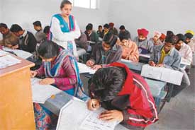 Students take part in a general knowledge test on Sunday