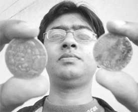 Dr Sharat Gupta of Patiala displays ancient temple coins from his collection