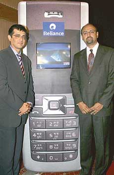 Global Broadcasting Company Ltd. Chief Executive Officer Sunil Lulla (left) and Reliance Infocomm official Mahesh J. Prasad pose at the launch of Times Now news channel on Reliance mobile phones in Mumbai on Monday. 