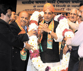 BJP national president Rajnath Singh being garlanded by Delhi traders during a civic reception at FICCI Auditorium in the Capital