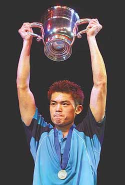 Chinas Lin Dan holds up his trophy after beating South Koreas Lee Hyun-il during in the final of the All England badminton championships in Birmingham on Sunday
