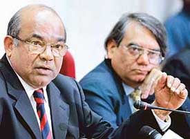 RBI Governor Y.V. Reddy gestures at a press conference as Dy Governor Rakesh Mohan looks on in Mumbai on Tuesday