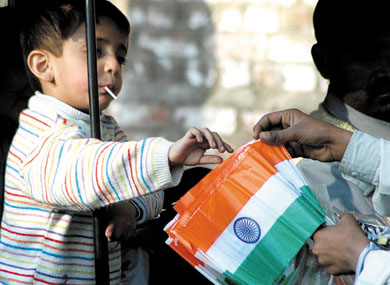 R-Day Spirit: A child buying a replica of the tricolour from a street vendor in the Capital on Tuesday