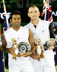 Leander Paes and the Czech Republics Martin Damm hold the runners-up trophies after losing to Bob Bryan and Mike Bryan of the USA in the mens doubles final at the Australian Open in Melbourne on Saturday