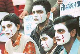 Members of the UT Government School Contract Teachers Association and their children paint their faces with red tears during their silent protest march against the Chandigarh Administration from Sector-23 to the Matka Chowk on Monday