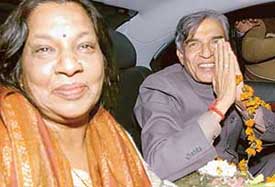 Mr Pawan Bansal, flanked by his wife, greets his supporters on his arrival in Chandigarh on Monday evening