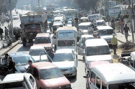 Vehicles stuck in a traffic jam at Kapurthala Chowk in Jalandhar on Tuesday. The traffic chaos resulted from a dharna staged by the relatives of a former PTU employee, who committed suicide on Monday. 