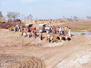 Villagers construct a bridge over Jassowal drain near Ludhiana.
