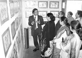 S.C. Bhattacharya explains to visitors the theme of female foeticide depicted in his cartoons at an exhibition held in Nangal recently