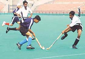 Neeraj of Haryana is checked by a Rajasthan player during the 51st National School Games at the Sector 42 stadium, Chandigarh