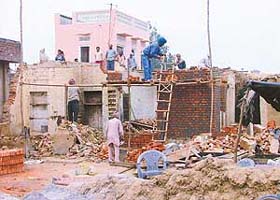 Construction work begins at the house of a Dalit in Bains village
