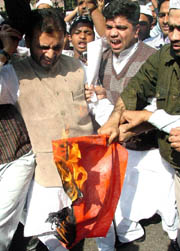 People under the banner of the Raza-e-Rasool Council burn the flag of Denmark at Jantar Mantar in New Delhi on Tuesday. 