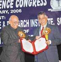 Col (Dr) C.S. Pant (right), former President of the Indian Radiological and Imaging Association, receives the Bhagwan Dass Arora Memorial Oration Award from the General President of the Indian Science Congress Association, Dr Ramamurthi Rallapalli, on the opening day of the ninth Punjab Science Congress at Guru Nanak Dev Dental College and Research Institute, Sunam, Sangrur district, on Tuesday.