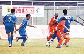 Dempo Sports Clubs Bolaji Majeck (No. 2) being challenged by JCTs Marcos Pereira (No. 16) and Baldeep Singh during a National Football League match in Ludhiana