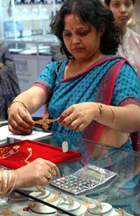 A woman tries out a gold bracelet during an exhibition, entitled Sonar Sansar, in Kolkata, on Friday. The exhibition, which sees the participation of some 50 Indian jewellery houses, will continue till Monday. 