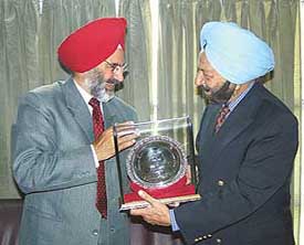 PAU Vice-Chancellor K.S. Aulakh presents a memento to the Manipur Governor, Dr S.S. Sidhu, in Ludhiana on Friday. 
