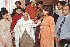 Mrs Ram Murti, sister of sepoy Gurbaksh Singh who had died as a prisoner of war in 1948, along with next of kin of other army personnel at a function in Chandimandir