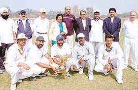 Members of the victorious Advisers XI after winning the Samuel Banerjee cricket cup at the Sector 16 stadium in Chandigarh